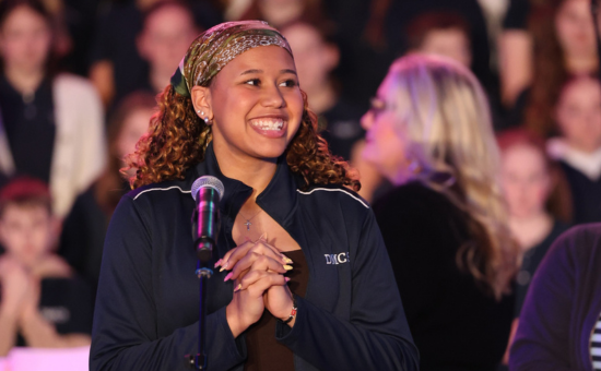 girl smiling by microphone